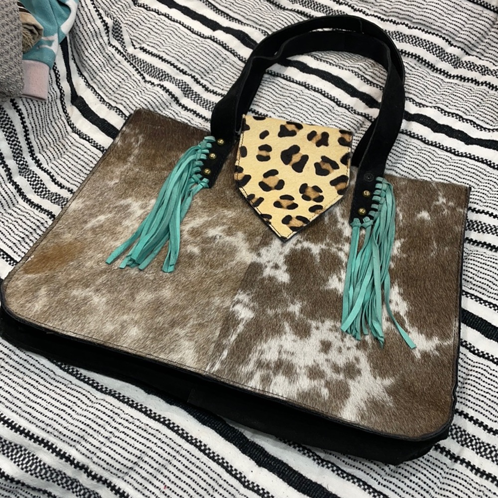 Local boutique Cowhide purse in great condition, missing one button see Picts.